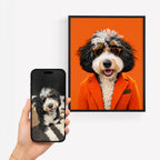 A framed custom pet portrait print of a dog in an orange blazer and sunglasses, displayed next to a hand holding a smartphone that shows the pet who's in the custom pet portrait.