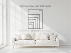 A vertical wall art size guide diagram displayed on a white wall above a modern white sofa in a bright, minimalist room. The diagram shows nested rectangular frames with dimensions in inches and a line indicating sofa size is 92 inches.